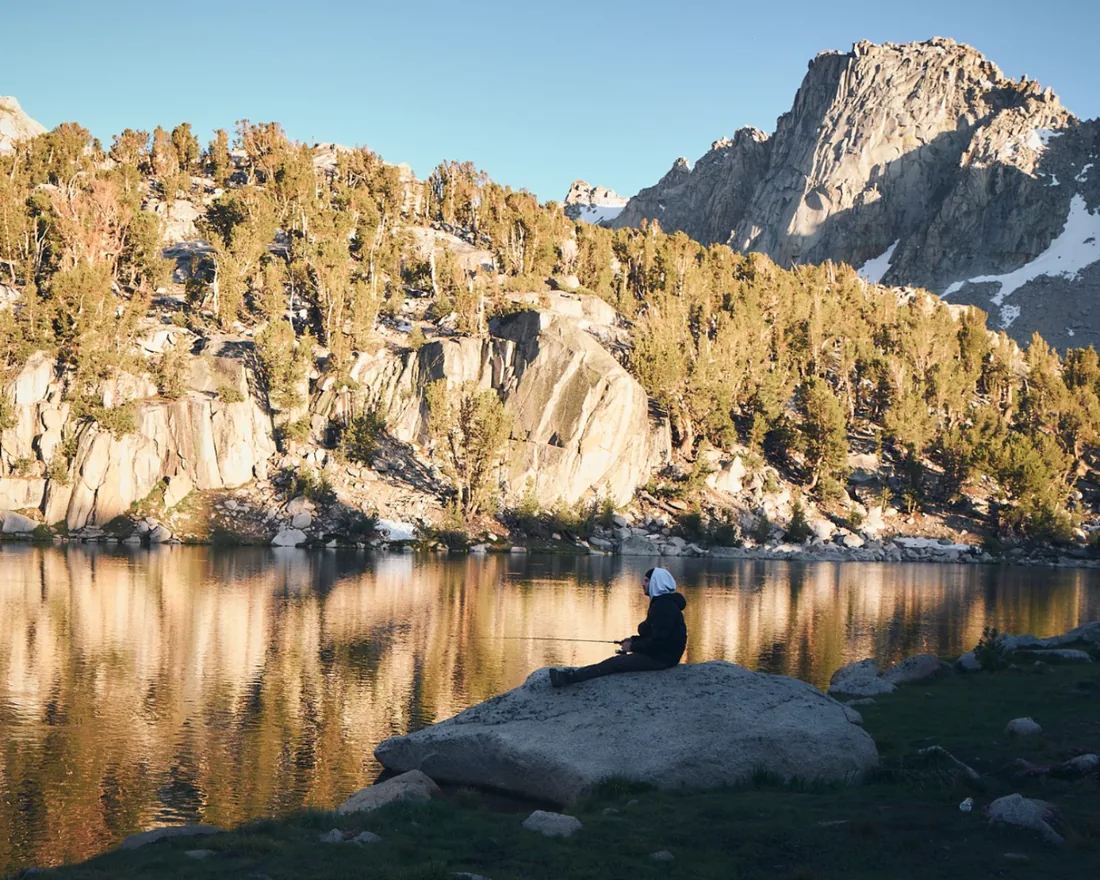 Griffin Carter fishing on an alpine lake in the Sierra Nevada